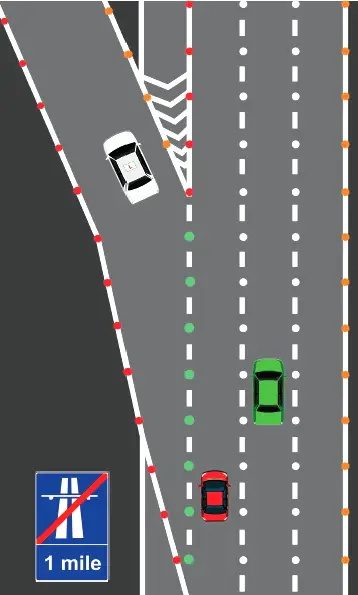 What colour are the reflective studs between the hard shoulder and the left-hand lane of a motorway?