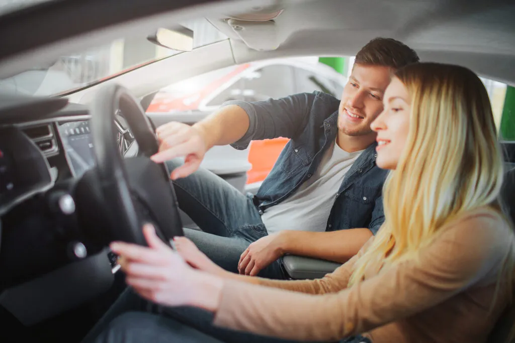 A novice driver is able to steer a straight course. How could you help them improve their steering skills