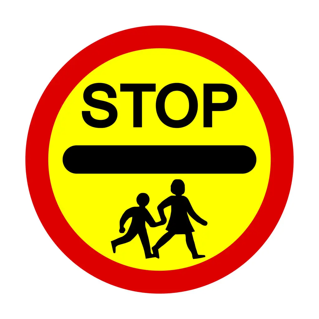 School Crossing Patrol Signs and How They’re Used
If you’ve ever walked or driven past a school at pick-up or drop-off time, you’ll know how busy and hectic it can get. To keep children safe, the law gives extra powers to School Crossing Patrols — often called “lollipop men” or “lollipop ladies” — who use a very distinctive sign.
Let’s break down exactly what the sign means, how it’s used, and what drivers need to do.
What the Sign Looks Like
The School Crossing Patrol sign is hard to miss:
A large, round sign on a stick, with a red border, yellow background, and the word “STOP” in black.
A black horizontal line runs through the middle, with silhouettes of children walking underneath.
It’s often called the “lollipop sign” because of its shape.
By law, this sign gives the patrol officer the authority to stop traffic so that children and parents can cross safely.
When It’s Used
School Crossing Patrols usually operate:
Before and after school hours when children are arriving or leaving.
Near school entrances, busy junctions, or pedestrian routes that see heavy use.
In all weathers — from sunny mornings to dark, rainy afternoons — visibility is vital, which is why the sign is so bold and reflective.
What Drivers Must Do
When a patrol officer steps into the road and raises the sign:
You must stop — it’s a legal requirement.
Wait patiently while children and parents cross.
Do not move off until the patrol has stepped back onto the pavement and lowered the sign.
Failing to stop for a School Crossing Patrol is not just dangerous — it’s an offence that can lead to fines, points on your licence, and even prosecution.
Why It Matters
The presence of a School Crossing Patrol is about safety first. Children can be unpredictable near roads, and traffic around schools can get chaotic. The sign provides a clear, respected command for drivers, giving children the confidence to cross safely.
Key Points for Learner Drivers
Always approach schools with extra caution.
Look out for the patrol officer in high-visibility clothing.
The “STOP” sign has the same force as a police officer’s signal — you must obey it.
Never wave children across yourself — leave that job to the patrol.
Final Word
The School Crossing Patrol sign is one of the most important on UK roads, not because it’s complicated, but because it protects the most vulnerable. As a driver, treating it with respect shows maturity, patience, and real responsibility behind the wheel.